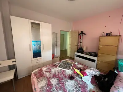 Cozy bedroom with wardrobe, dresser, and exercise equipment, perfect for personal relaxation and fitness.