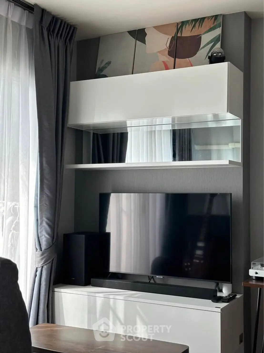 Modern living room with sleek TV setup and stylish shelving