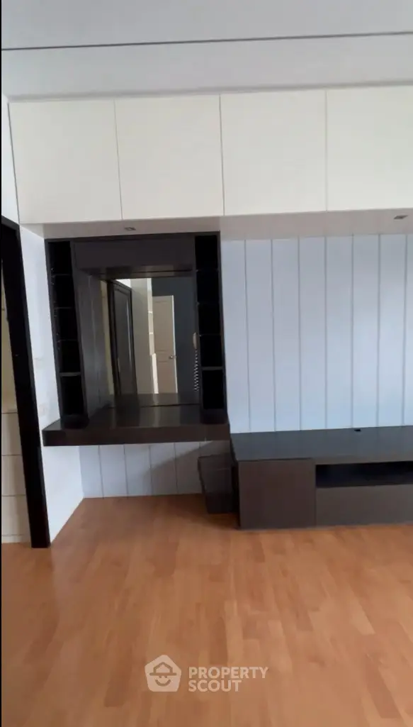 Modern interior with sleek built-in storage and wooden flooring