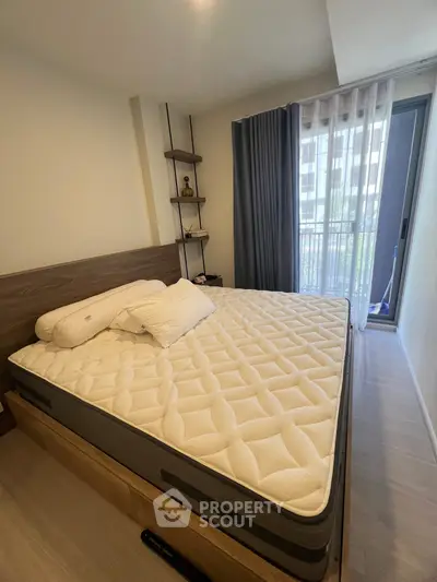 Cozy bedroom with modern decor and large window for natural light