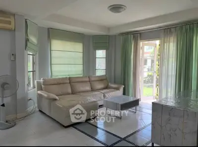 Spacious living room with elegant sofa and garden view