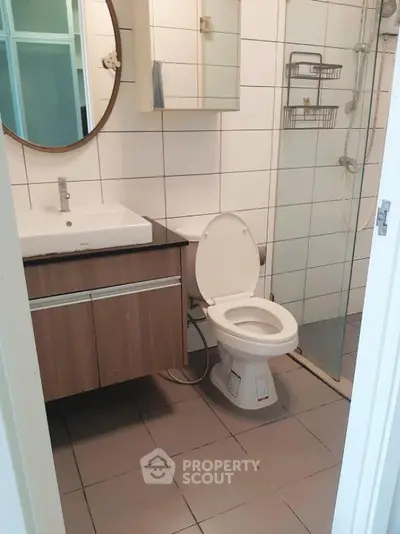 Modern bathroom with sleek fixtures and glass shower enclosure