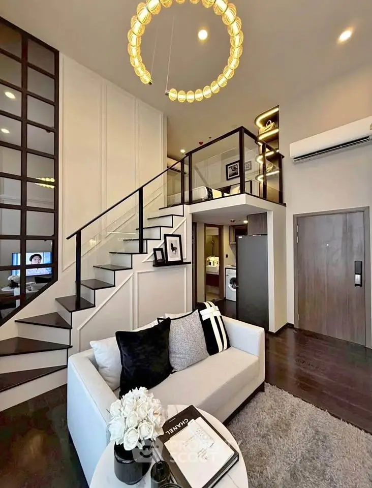 Modern loft apartment with stylish living room and mezzanine bedroom, featuring elegant decor and open layout.