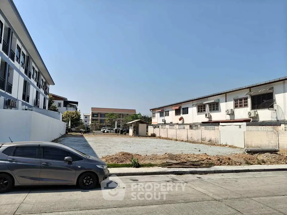 Vacant land plot in urban area with potential for development, surrounded by residential buildings.