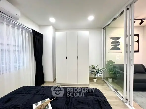 Modern bedroom with sleek wardrobe and stylish decor in a contemporary apartment.