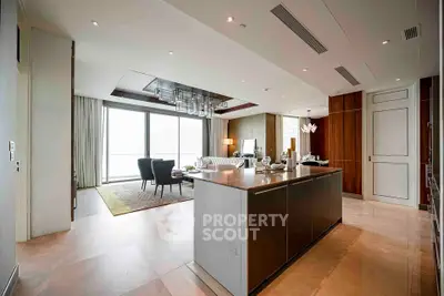 Luxurious open-plan living room with modern kitchen island and panoramic windows.