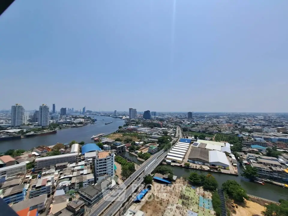 Stunning panoramic cityscape view from high-rise building overlooking river and skyline.
