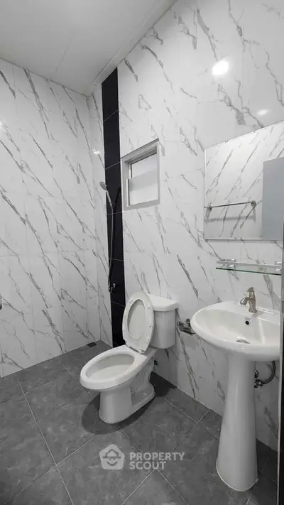 Modern bathroom with marble tiles and sleek fixtures