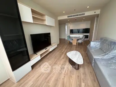 Modern living room with sleek furniture and open kitchen layout