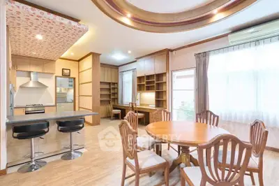 Spacious open-plan kitchen and dining area with modern furnishings and ample natural light.