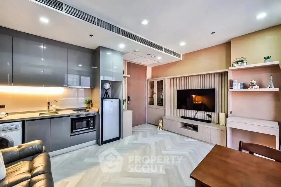 Modern open-plan living room with sleek kitchen and cozy seating area