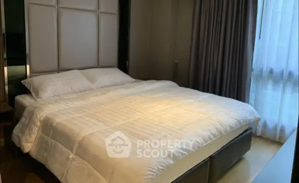 Luxurious bedroom with elegant decor and large window for natural light