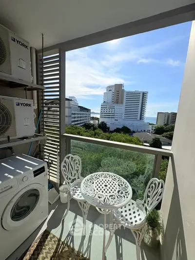 Charming balcony with city view and cozy seating area, perfect for relaxation.