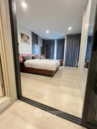 Spacious modern bedroom with elegant decor and large windows