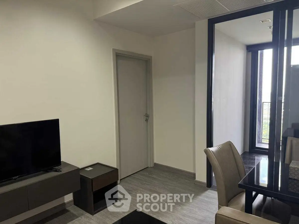 Modern living room with sleek furniture and balcony access