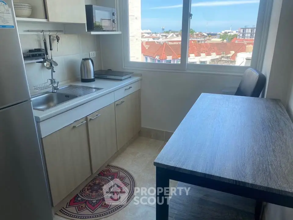 Cozy kitchen with a view, featuring modern appliances and ample natural light.