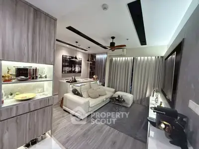 Modern living room with stylish decor and open layout, featuring cozy seating and elegant lighting.