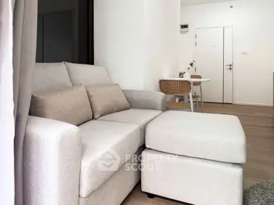 Modern living room with cozy beige sofa and stylish dining area