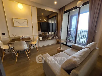 Modern living room with stylish decor and balcony view in high-rise apartment
