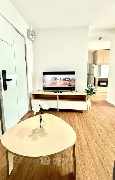 Modern living room with wooden flooring and stylish furniture in a bright apartment.