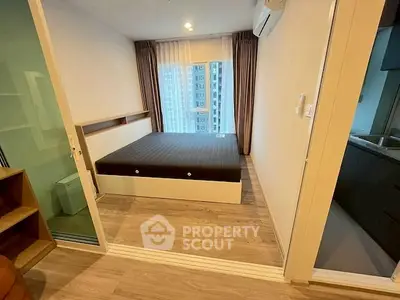 Modern bedroom with large window and wooden flooring in a high-rise apartment.
