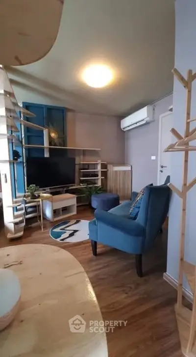 Charming living room with modern decor and cozy seating area, perfect for relaxation.