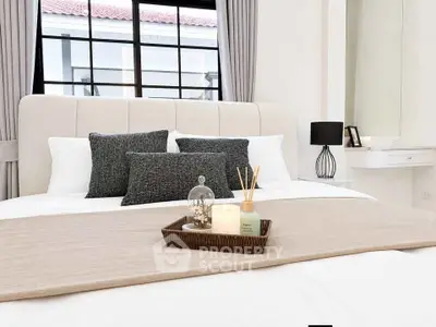 Luxurious bedroom with elegant decor and large window for natural light