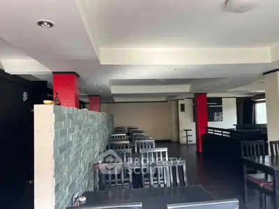 Spacious restaurant interior with modern decor and ample seating, ideal for dining and social gatherings.