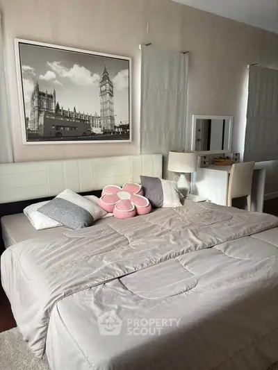 Cozy bedroom with stylish decor and elegant furniture, featuring a large bed and a chic dressing table.