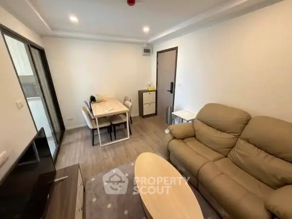 Modern living room with cozy seating and dining area in a stylish apartment.