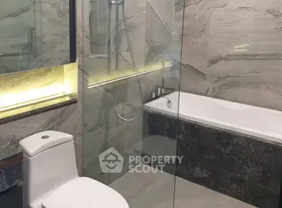 Luxurious modern bathroom with glass shower and elegant bathtub