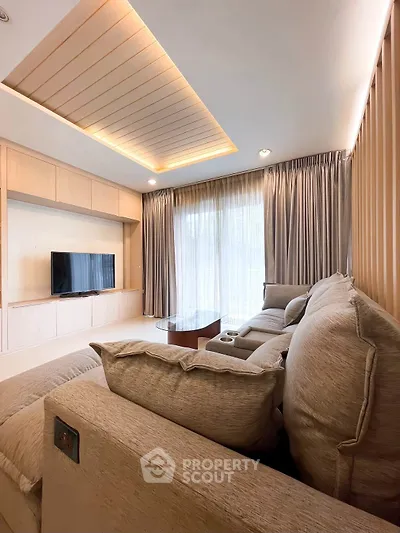 Luxurious living room with modern decor and large windows for natural light.