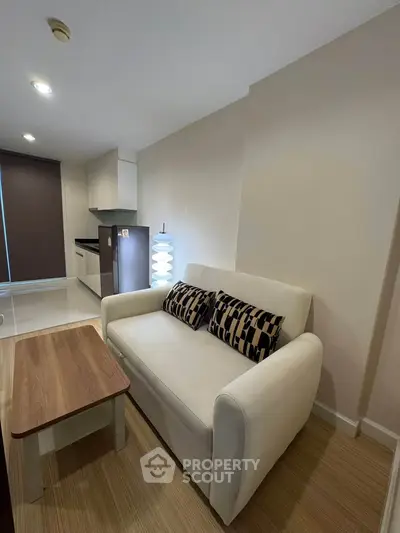 Modern living room with cozy sofa and stylish decor in a contemporary apartment.