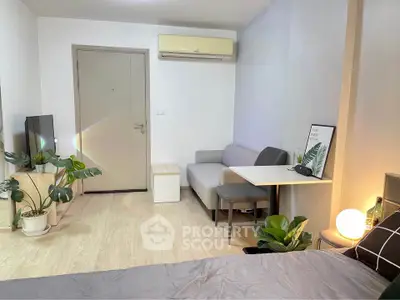 Modern studio apartment with cozy living area and stylish decor