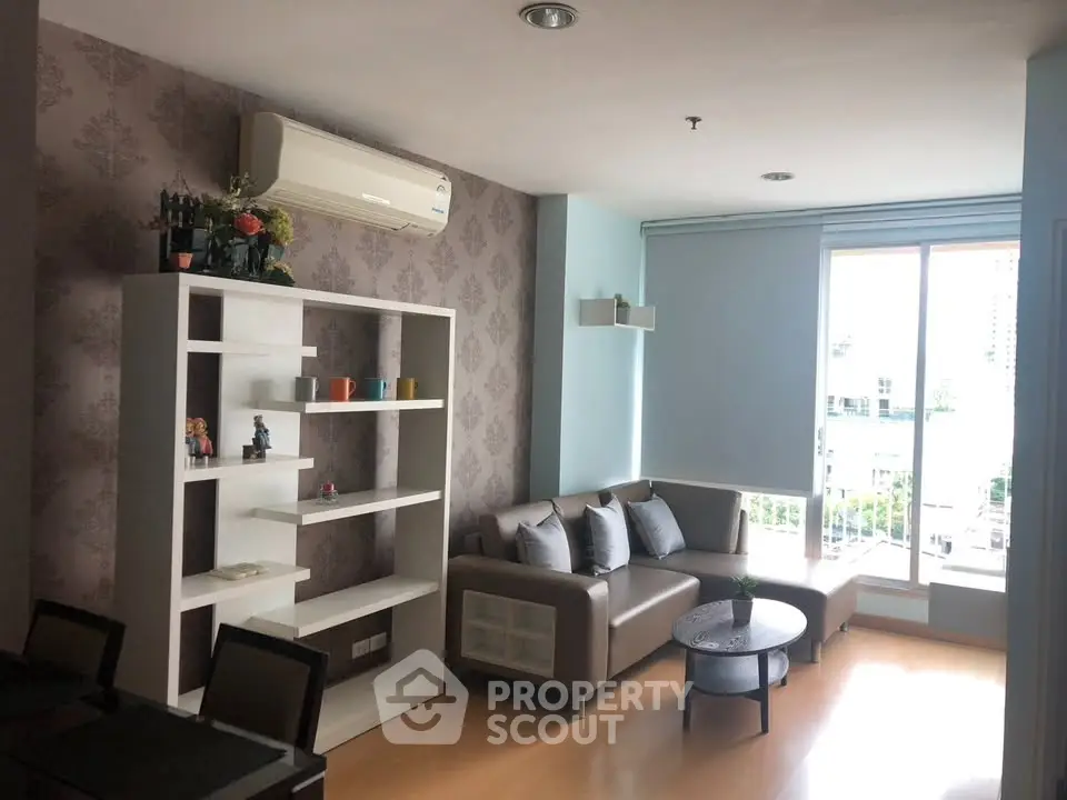 Modern living room with stylish decor and large windows offering natural light.