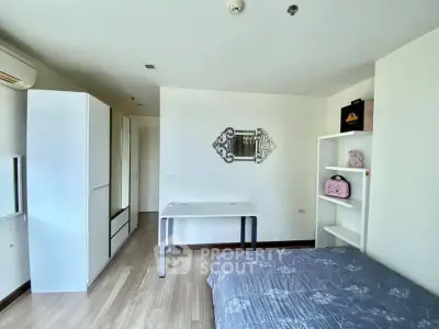 Modern bedroom with sleek furniture and stylish decor in a bright apartment.