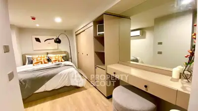 Modern bedroom with stylish decor and ample storage in a cozy apartment.