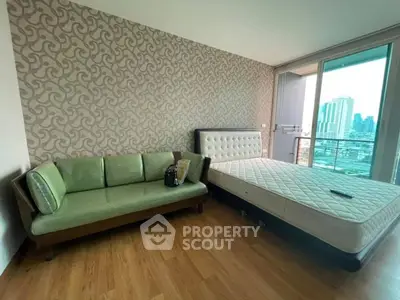 Modern bedroom with city view, featuring stylish furniture and elegant decor.