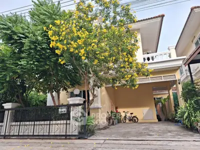 Charming two-story house with lush garden and spacious driveway in a serene neighborhood.