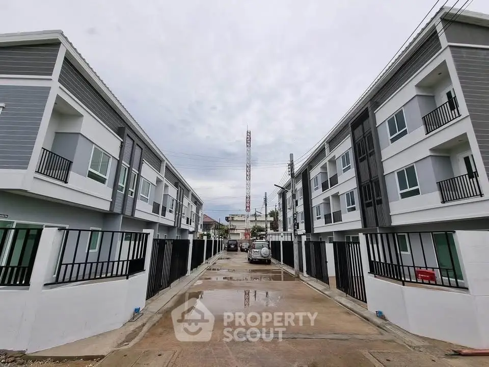 Modern townhouse complex with sleek design and spacious driveways, perfect for urban living.
