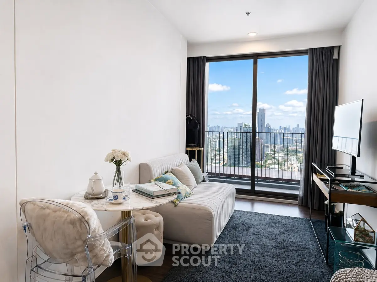 Modern living room with stunning city view, elegant decor, and cozy seating area in high-rise apartment.