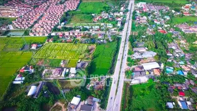 Aerial view of suburban real estate development with lush greenery and residential areas.