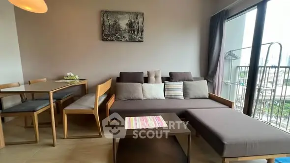 Modern living room with stylish furniture and balcony view in a cozy apartment.