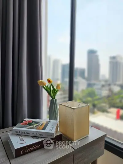 Stylish interior with city view, featuring elegant decor and natural light.