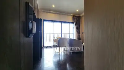 Modern living room with large windows and elegant furniture, offering a bright and inviting atmosphere.