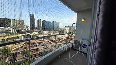 Spacious balcony with city skyline view in modern apartment