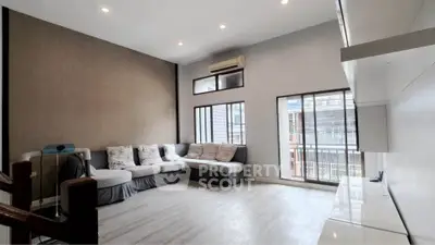 Spacious living room with modern decor and large windows for natural light.