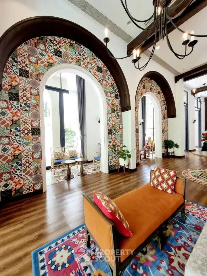 Stunning living room with vibrant decor and arched mosaic accents, perfect for luxurious entertaining.