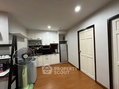Modern kitchen with sleek cabinets and appliances in cozy apartment