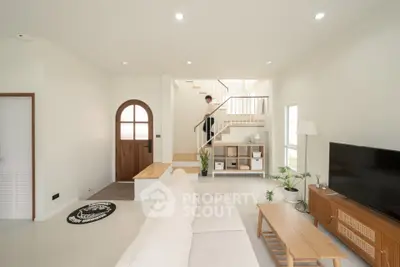 Modern living room with stylish furniture and open staircase design